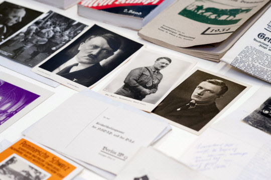 epa05539436 Photographs and documents showing Nazi leader Adolf Hitler from a time capsule are presented at the National Museum in Szczecin, Poland, 14 September 2016. The time capsule with historic coins, archival German newspapers, pictures, promotion movie of Falkenburg - the old name of Zlocieniec town, and an appeal to the future residents was found couple days ago in Zlocieniec town, north-west Poland. It was buried 80 years ago under the construction of the Ordensburg Krossinsee center that educated future Nazi employees and officers. Documents and other memorabilia will be translated and preserved and then made available to the citizens of Zlocieniec.  EPA/TOMASZ MURANSKI POLAND OUT